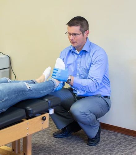 Chiropractor Watertown SD Bryan Dingsor With Foot