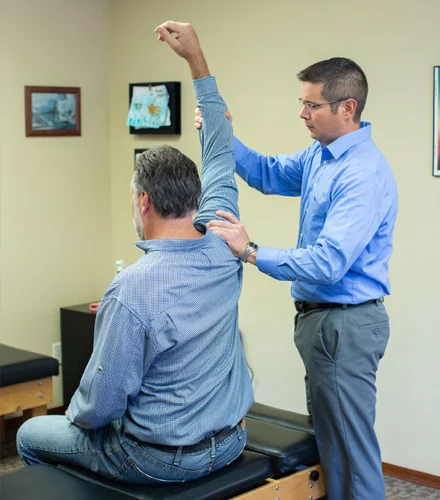 Chiropractor Watertown SD Bryan Dingsor With Male Shoulder Pain Patient